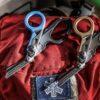 two_raptor_rescues_with_closed_shears_laying_on_top_of_a_backpack_20260402201735